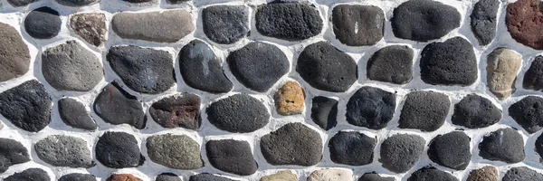 Stein Hintergrund Wand aus runden Steinen — Stockfoto