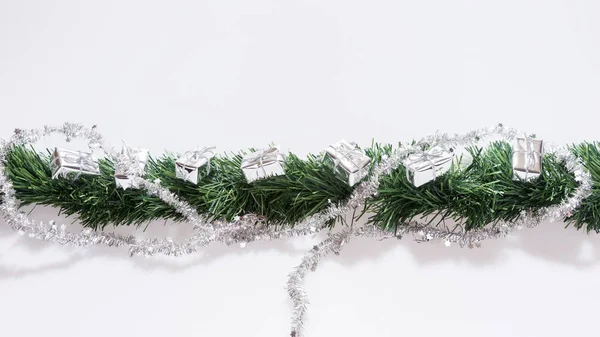 Christmas garland with silver gift boxes — Stock Photo, Image