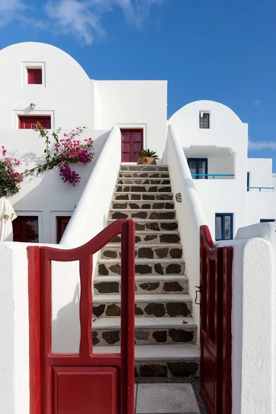 Open door with stairs to the top in the city of Oia, Santorini