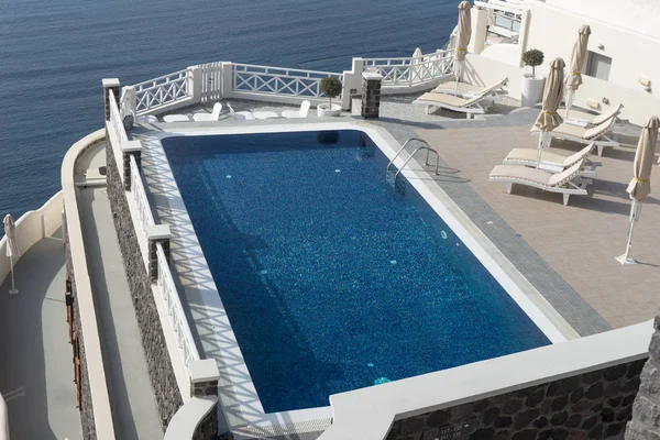Empty swimming pool on the terrace in Fira, Santorini Island