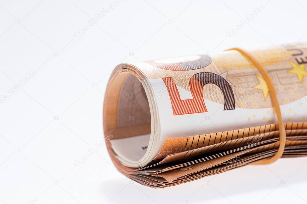 A roll with fifty euro banknotes on white background