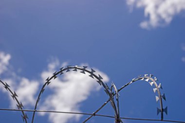 Güvenlik çit dikenli tel mavi gökyüzü bulutlu