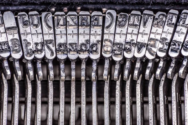 Numbers and letters on an old typewriter machine macro shot