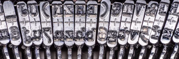 Numbers and letters on an old typewriter machine macro shot