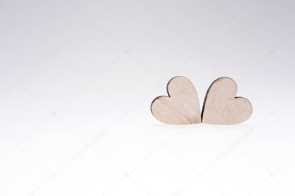 Two wooden hearts isolated, concept for love, dating and romance with copy space