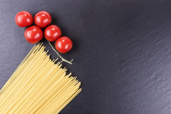 Yellow Long Raw Spaghetti Cherry Tomatoes Black Slate Plate — Stock Photo, Image