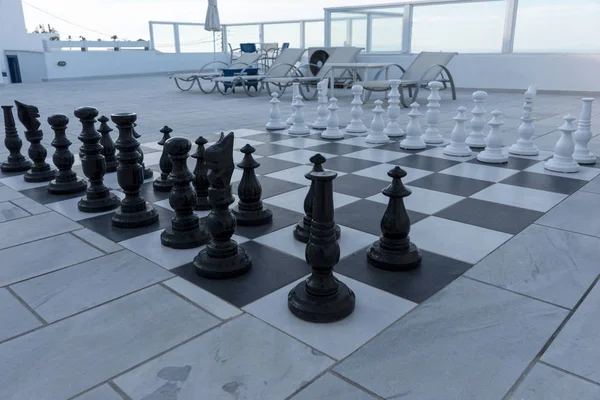 Large chess pieces on the outdoor terrace. Outdoor chess game