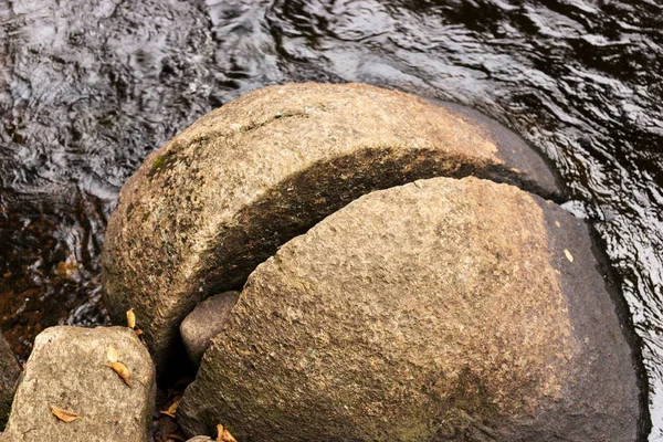 Split big round stone in the river