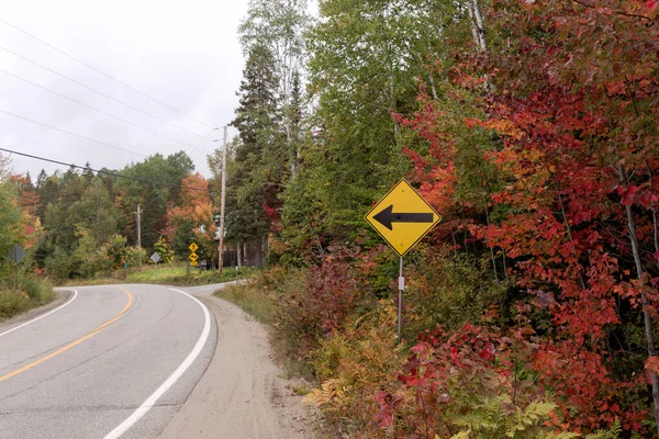 Yellow arrow traffic sign on the street. Canada