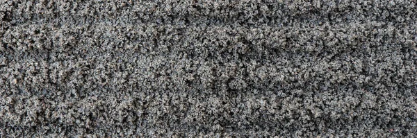 Dark gray fine gravel stones as background or texture