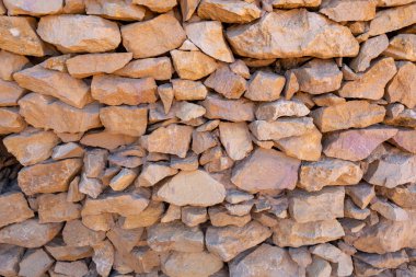 Old stone wall background pattern, constructed with natural rocks different shape