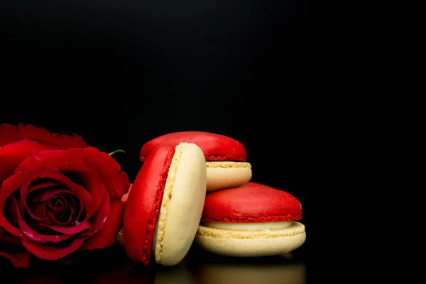 macaroons .red  macaroons with red rose on black background  and big red heart