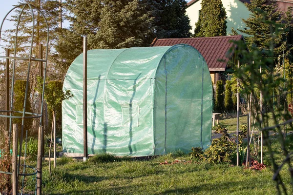 Home greenhouse in the garden, the concept of growing your own vegetables
