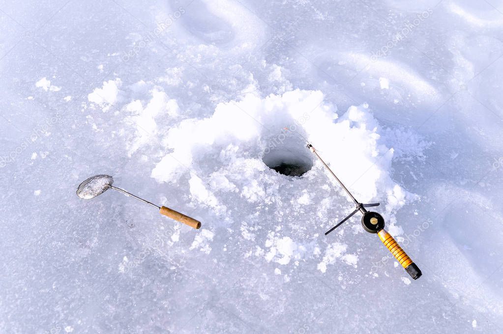 Hole in the ice and fishing rod
