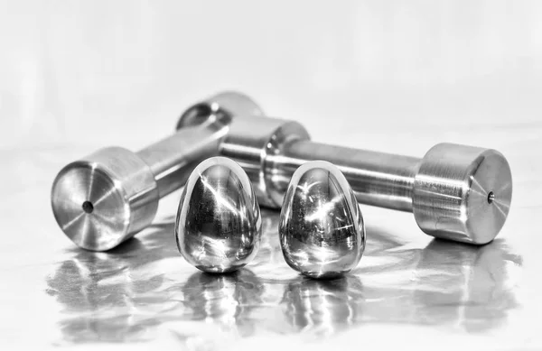 Metal dumbbells and steel eggs, the concept of sports training a — Stock Photo, Image