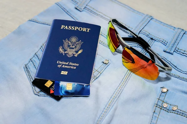 Passport with bank cards, glasses and seashells. The concept of travel. — Stock Photo, Image