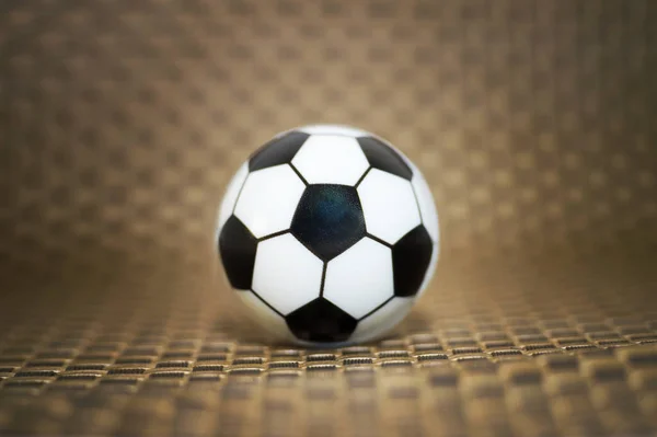 A toy soccer ball on an artificial background. Concept of the game of football. — Stock Photo, Image