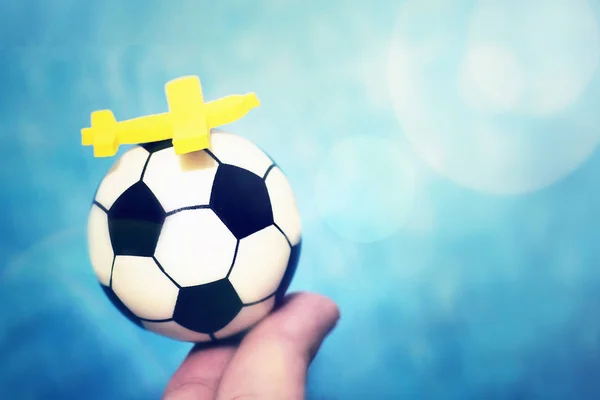 Aereo giocattolo giallo su un pallone da calcio. Il concetto di volare al campionato di calcio . — Foto Stock