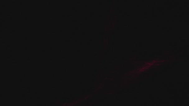 Pois rouges et reflets se déplaçant sur fond noir. Système de sécurité laser. Illusion optique .