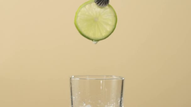 Tea Ceremony Hand Puts Lime Transparent Glass Ice Cubes Table — Stock Video