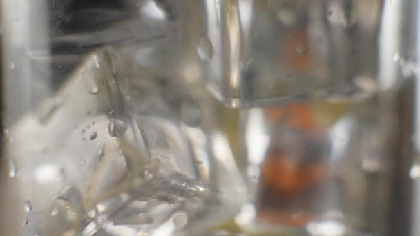 Close Fresh Orange Juice Flows Shiny Cold Ice Cubes Water — Stock Video