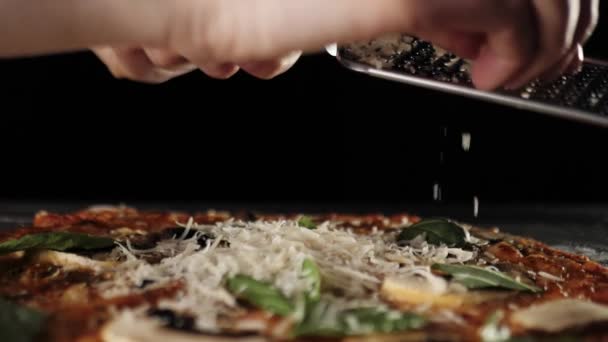 Professional Chef Rubs Parmesan Cheese Grater Grated Cheese Falls Pizza — Stock Video