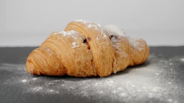 Fresh Croissant Chocolate Sugar Powder Rotates Black Board White Table — Stock Video
