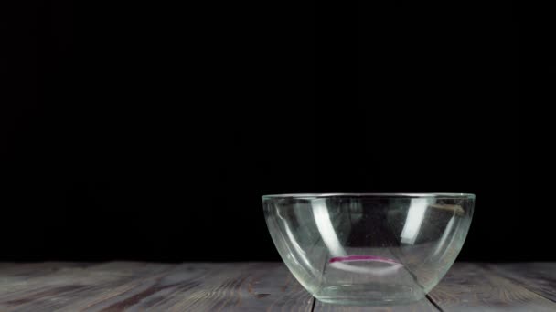 Sliced Purple Onion Falls Empty Glass Bowl Wooden Table Concept — Stock Video