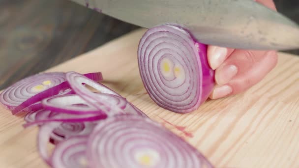女人用锋利闪亮的小刀在木板上切下新鲜的紫色洋葱 用生菜 樱桃西红柿 黄瓜和洋葱做夏季新鲜沙拉的概念 靠近点4K — 图库视频影像
