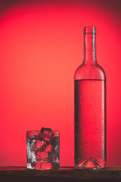 Refreshing Cold Drink Bottle Drops Glass Ice Red Background Iced — Stock Photo, Image