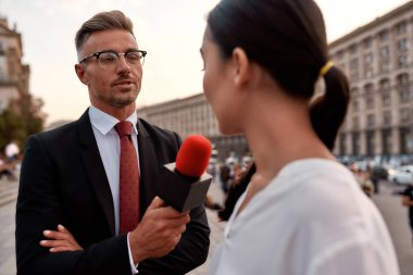 Şehir sokağında profesyonel bir muhabirle röportaj. Gazetecilik endüstrisi, canlı yayın konsepti