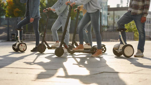 Porquê desperdiçar vida no trânsito? Joyful amigos montando scooters pontapé e segways — Fotografia de Stock