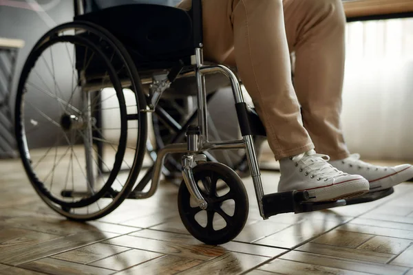 Cropped photo of male office worker in a wheelchair. Disabled man sitting on wheelchair in office. Disability and handicap concept — Stock Photo, Image