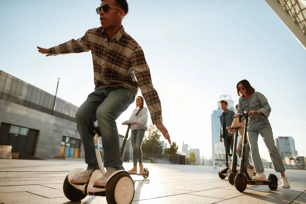 Time to ride. A group of friends using kick scooters and segways on a sunny day — 图库照片