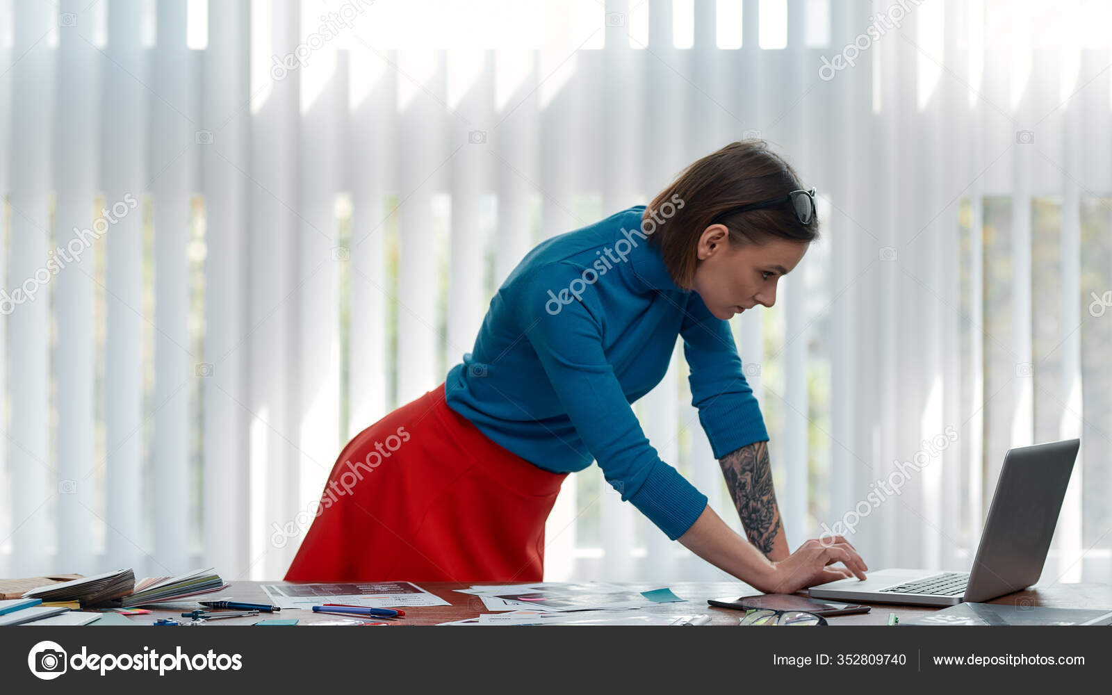 Busy working day. Focused female designer in casual wear working with