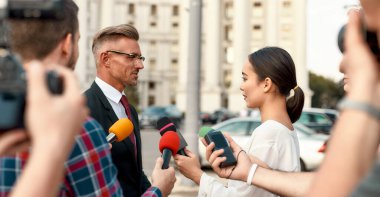 This is on the record. Journalists conducting interview of politician. Journalism industry, live streaming concept.