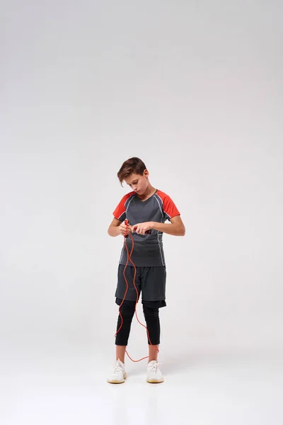 Jump more. Full-length shot of a teenage boy engaged in fitness, getting ready to skip using jump rope. Isolated on white background. Sport, training, fitness, active lifestyle concept — Stockfoto