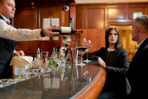 Boa noite. Duas pessoas de negócios casuais em um bar do hotel à noite tendo dois copos de vinho tinto após o check-in — Fotografia de Stock