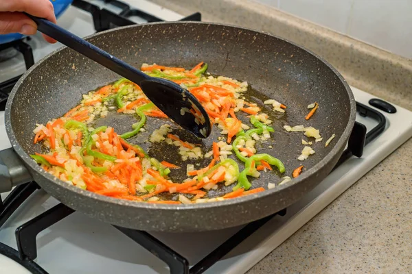 Roasting chopped vegetables on frying pan — Stock Photo, Image