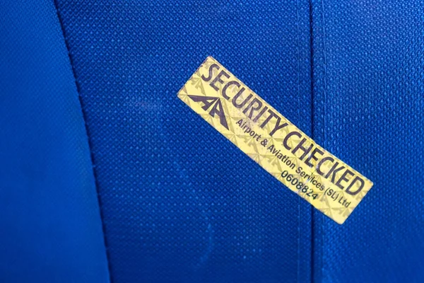 Close up security checked label on blue suitcase — Stock Photo, Image