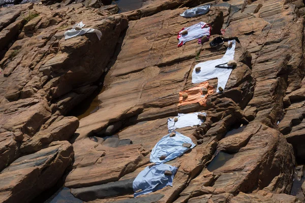 Clothes dry in the sun on rock in Sri Lanka