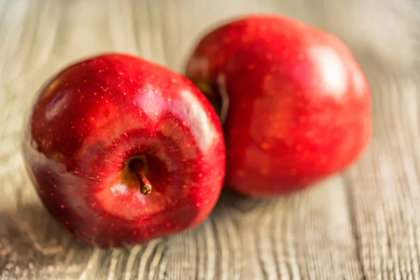 De rijpe appels rood sap op houten achtergrond — Stockfoto