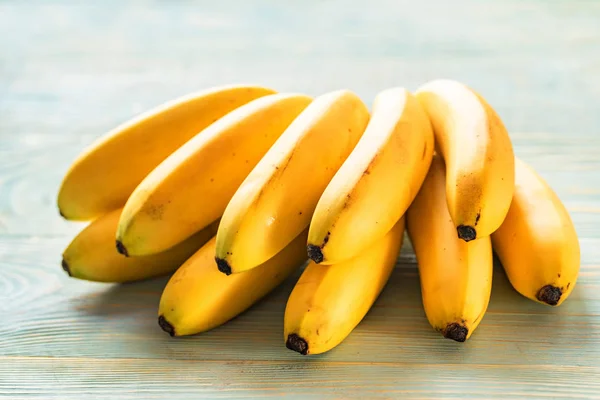 Bunch of bananas on wooden background — Stock Photo, Image