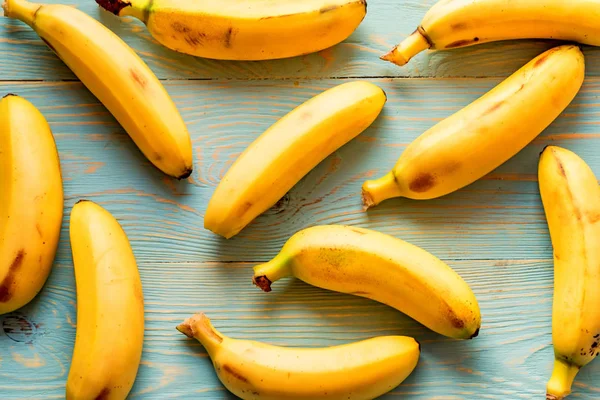 Bunch of bananas on wooden background — Stock Photo, Image