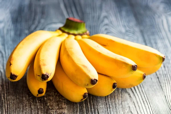 Bunch of bananas on wooden background — Stock Photo, Image