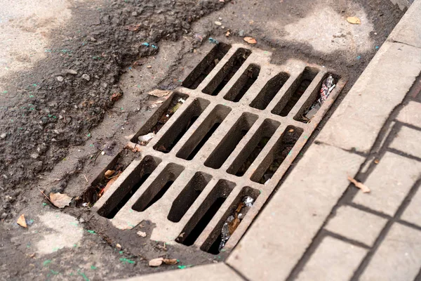 Storm drain on road — Stock Photo, Image