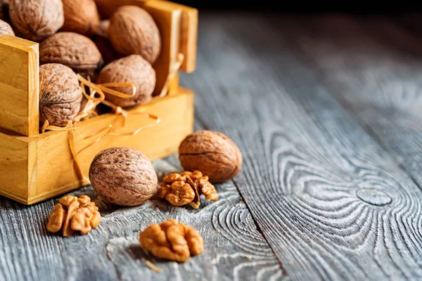 Walnuts in box on wooden backgound