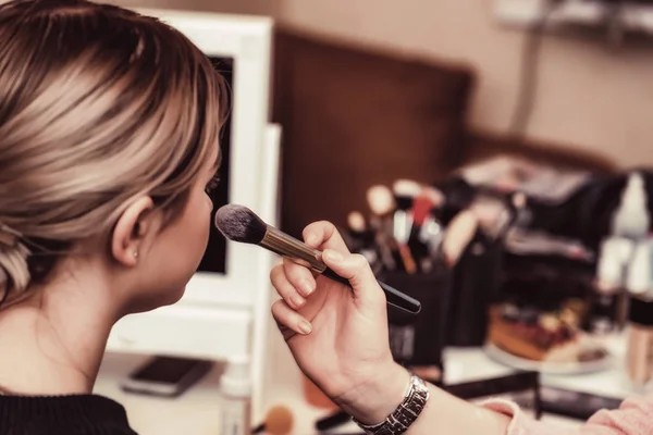 Visagistin schminkt Mädchen mit Pinsel — Stockfoto