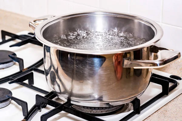 Boiling water for soup in modern saucepan — Stock Photo, Image