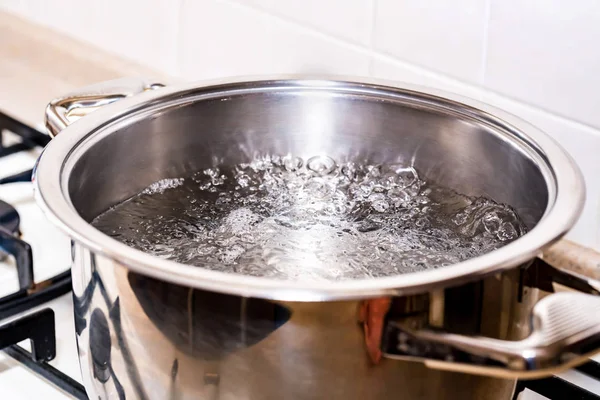 Boiling water for soup in modern saucepan — Stock Photo, Image